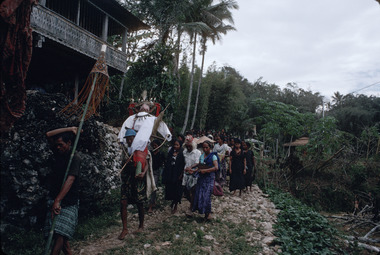 29. The effigy (tau-tau) on the way to the sacrificial field, preceded by the banners (tombi), Bokko, 1993., 29. L'effigie tau-tau en route vers le champ sacrificiel, devancée par les bannières tombi, à Bokko, septembre 1993. (French), 12). Patung tau-tau menuju arena penyembelihan. Ia didahului oleh panji-panji tombi, Bokko, 1993. (Indonesian) thumbnail