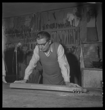 Monsieur René Cune, luthier d'art, prend les mesures d'une épinette qu'il a fabriquée la vignette